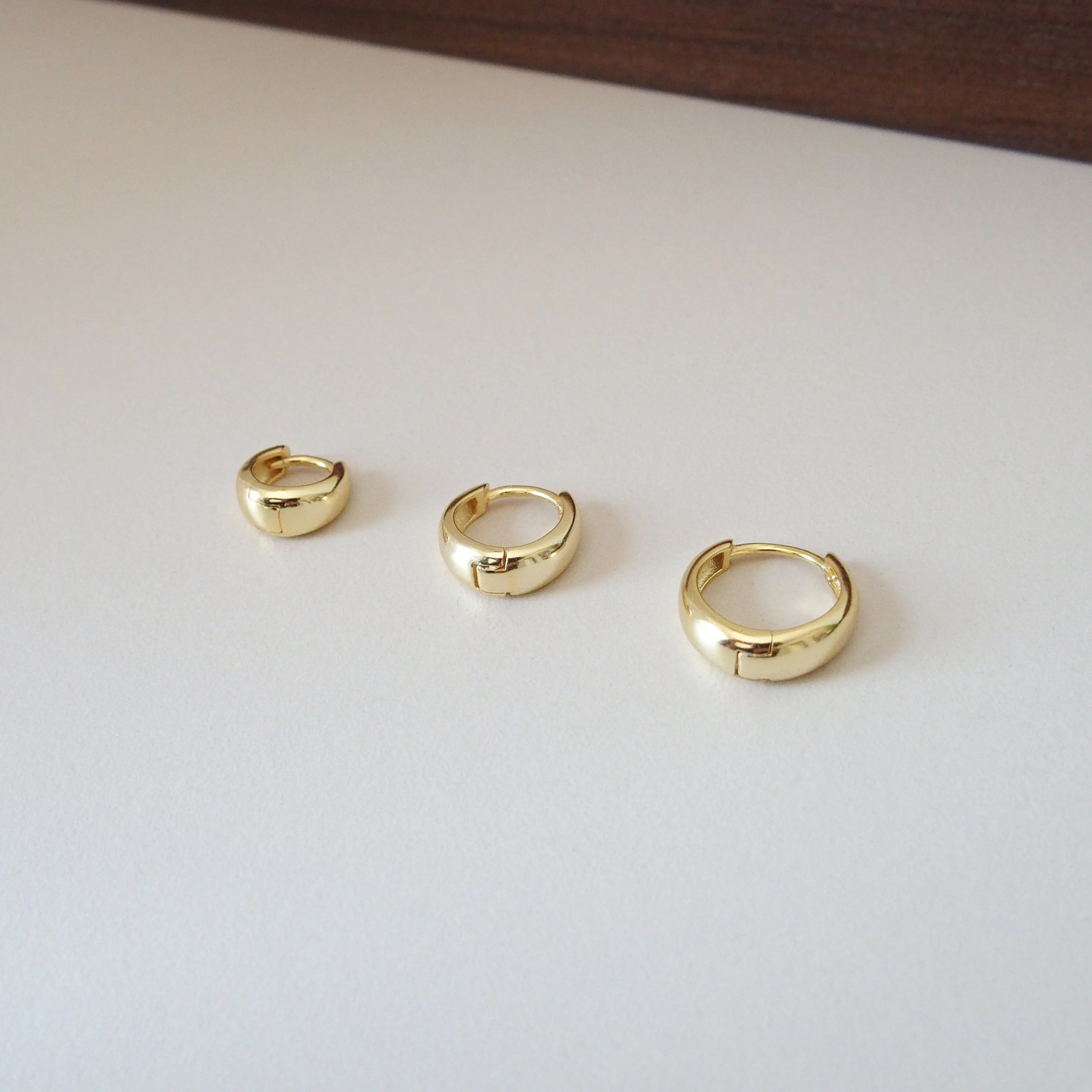 Tapered Huggie Hoops in Gold